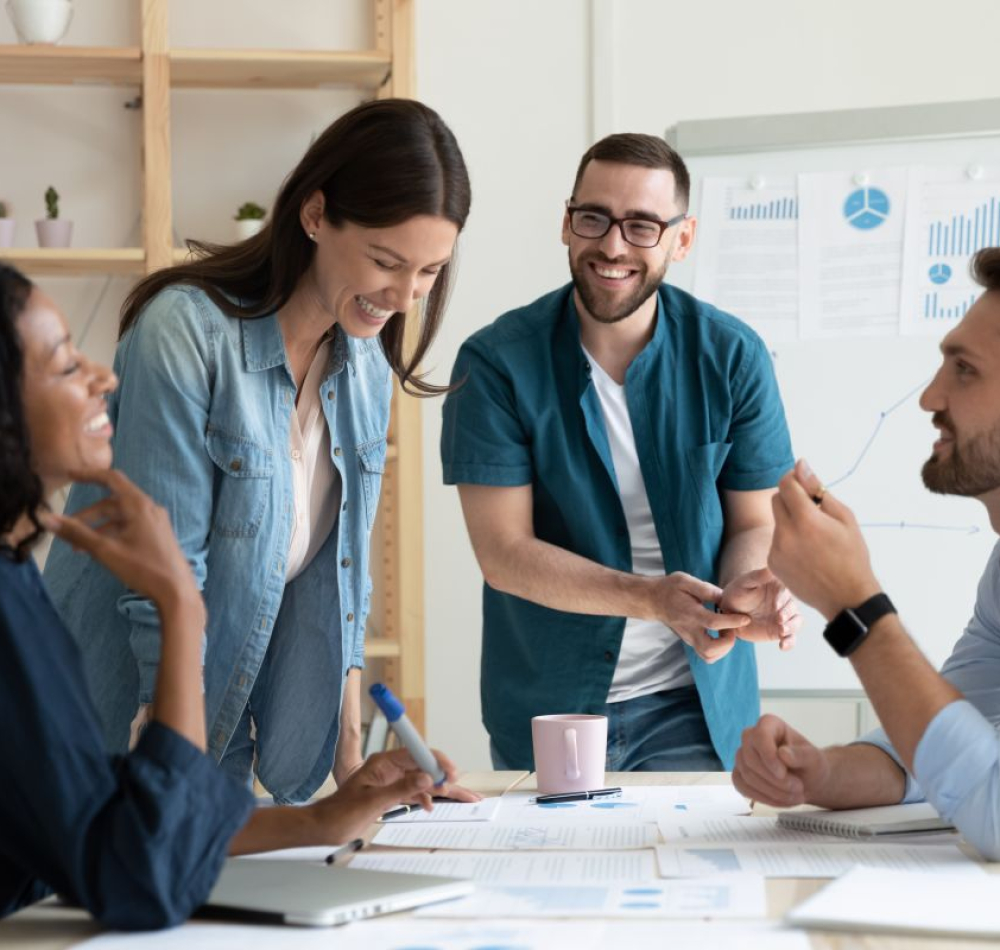 Smiling,Diverse,Colleagues,Gather,In,Boardroom,Brainstorm,Discuss,Financial,Statistics